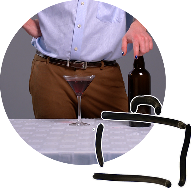 Icon of a suitcase with background photo of a martini glass against a person's crotch, giving the illusion of a female sex